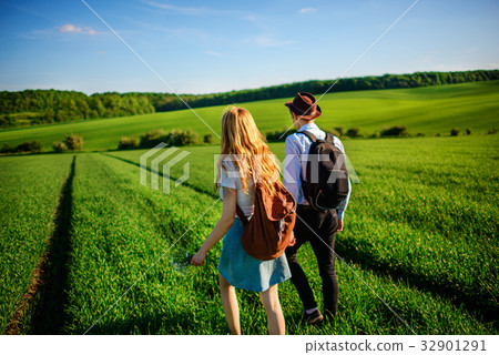 With a backpack, a man in a hat and a woman With a backpack, a man in a hat and a woman 32901291