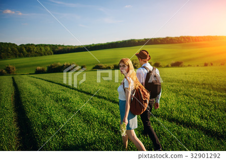 With a backpack, a man in a hat and a woman  32901292