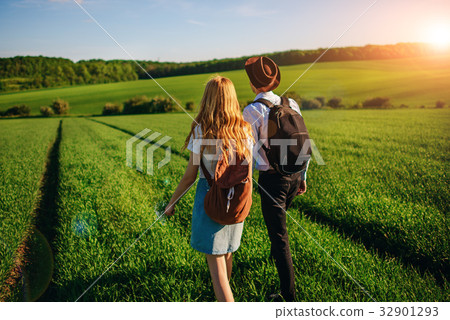 With a backpack, a man in a hat and a woman With a backpack, a man in a hat and a woman 32901293