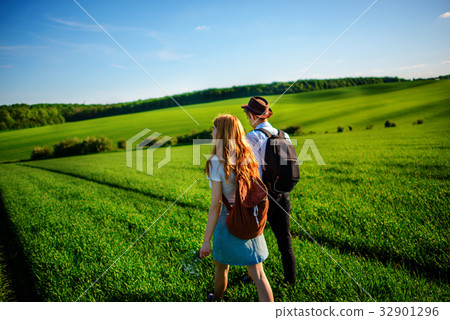 With a backpack, a man in a hat and a woman With a backpack, a man in a hat and a woman 32901296
