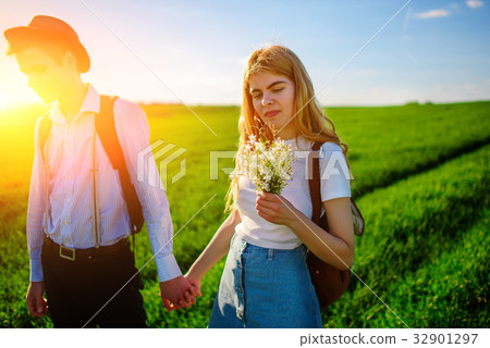 A pair of lovers are holdings their hands together A pair of lovers are holdings their hands together 32901297