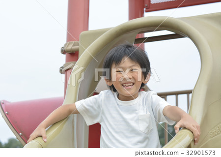 Boys playing on a slide Boys playing on a slide 32901573