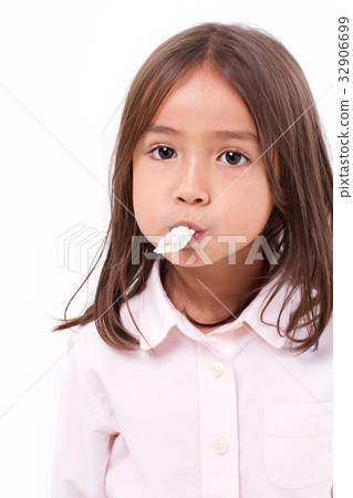 cute little girl eating sweet marshmallow 32906699