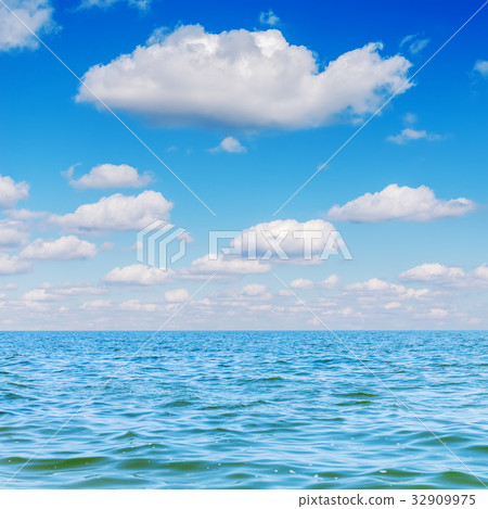 blue sea and clouds in sky over it 32909975