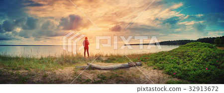 Log on the beach at sunset 32913672