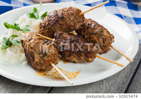 Barbecued kofta with rice on a plate 32915474