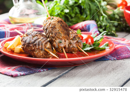Barbecued kofta with fries on a plate 32915478