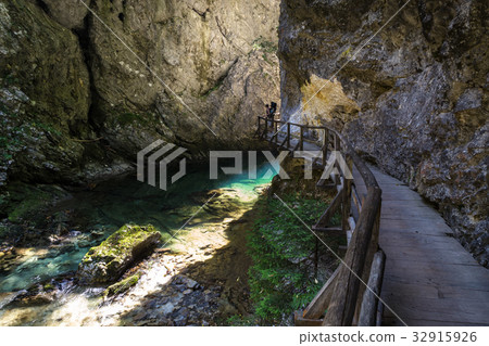 Man carrying child hiking in Vintgar gorge in 32915926