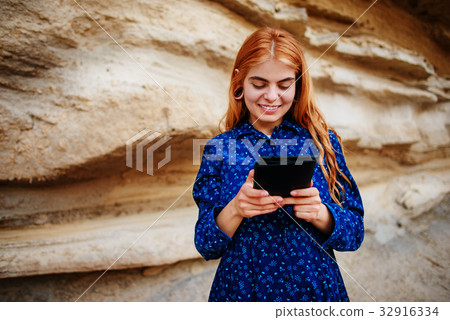 Beautiful woman smiling and looking at the screen Beautiful woman smiling and looking at the screen 32916334