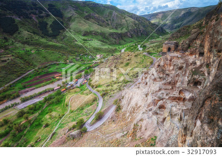 Tourists visiting Vardzia ancient cave city on a Tourists visiting Vardzia ancient cave city on a 32917093