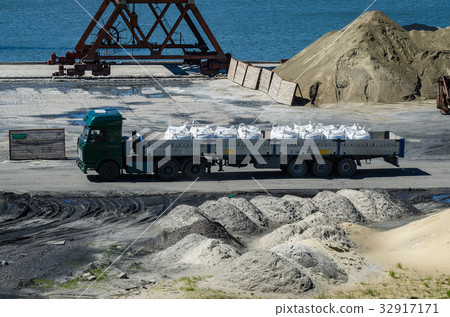 Crane in river port. Heavy cranes unloading metal Crane in river port. Heavy cranes unloading metal 32917171