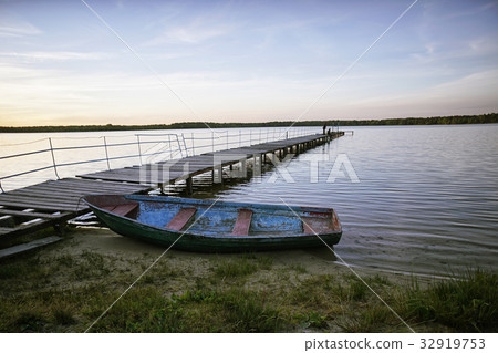 Landscape with a lake and boats. Landscape with a lake and boats. 32919753