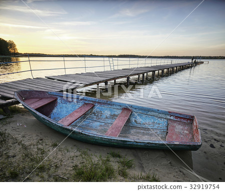 Landscape with a lake and boats. Landscape with a lake and boats. 32919754
