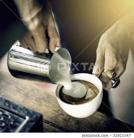 Coffee maker pouring the milk for make latte art 32921547