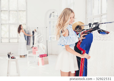 The young pretty girl choosing and trying on The young pretty girl choosing and trying on 32922531