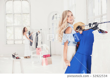 The young pretty girl choosing and trying on 32922534