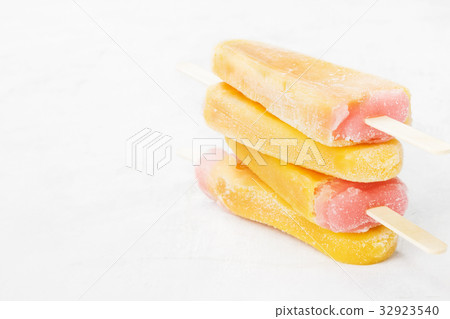 Multi-colored popsicles on a white background 32923540