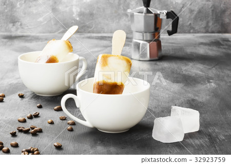 Coffee ice cream popsicles in white cups Coffee ice cream popsicles in white cups 32923759