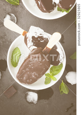 Vanilla ice cream on stick covered with chocolate Vanilla ice cream on stick covered with chocolate 32923805