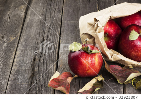 Apples in paper package on dark wooden background 32923807