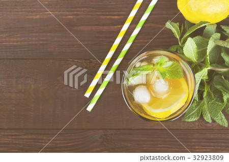 Ice tea with lemon and mint on a wooden background 32923809