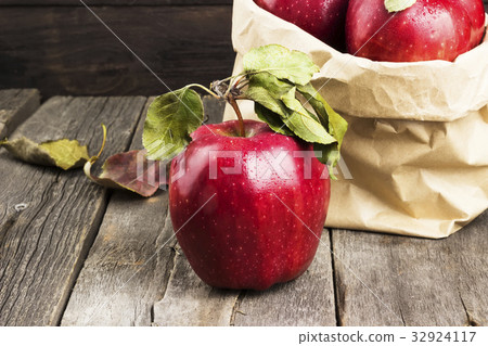 Apples in paper package on dark wooden background Apples in paper package on dark wooden background 32924117