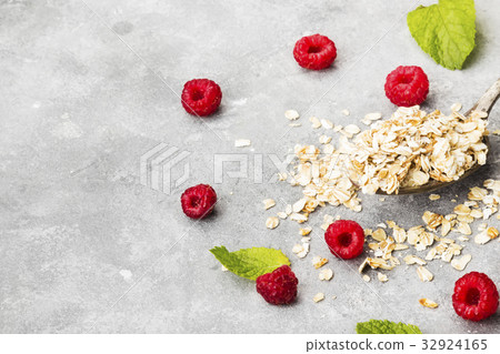 Glanola in spoon with raspberry and mint Glanola in spoon with raspberry and mint 32924165