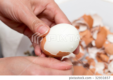 The girl is cleaning the egg with her hands The girl is cleaning the egg with her hands 32931657