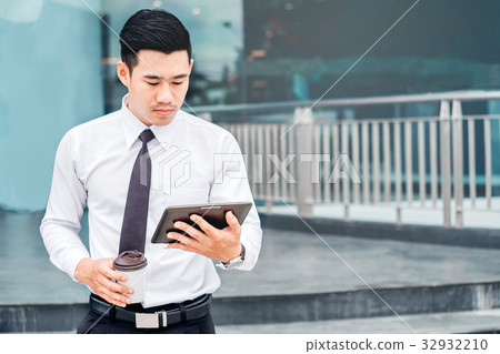 Businessman  With Coffee Using Digital Tablet  32932210