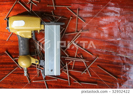 Air Nailer with rusty nail. Air Nailer with rusty nail. 32932422