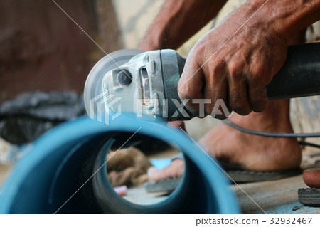 Electric circular saw cutting the PVC pipe Electric circular saw cutting the PVC pipe 32932467