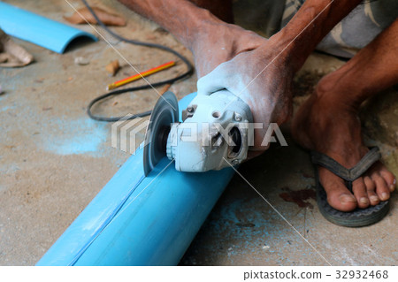 Electric circular saw cutting the PVC pipe Electric circular saw cutting the PVC pipe 32932468