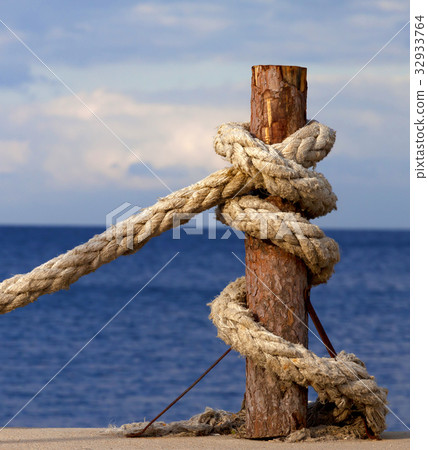 Rope on seafront and cloudy sky in autumn evening 32933764