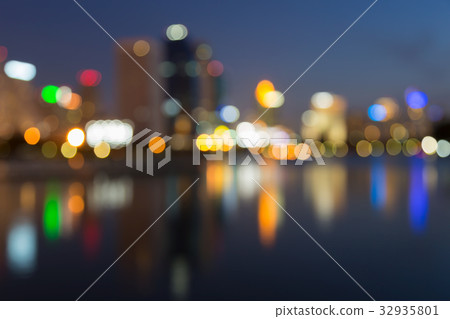 Blurred bokeh city light with water reflection Blurred bokeh city light with water reflection 32935801