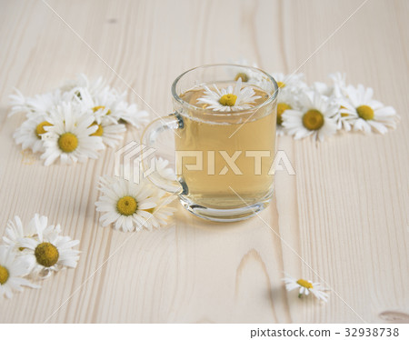 Chamomile tea among chamomile flowers Chamomile tea among chamomile flowers 32938738