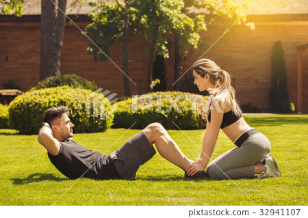 Young couple exercise together outdoors healthy Young couple exercise together outdoors healthy 32941107