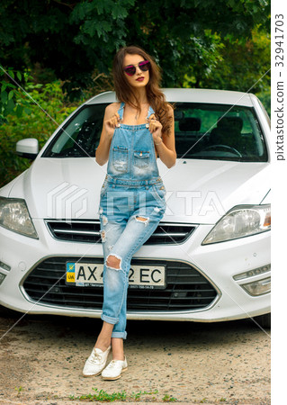 glamorous brunette posing near the white car 32941703