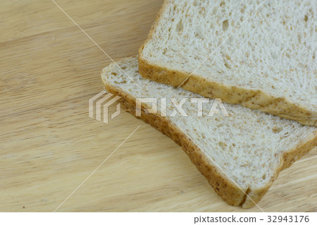 Bread whole wheat on wood background 32943176
