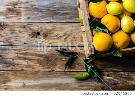 Box of fresh citrus lemon and orange with leaves Box of fresh citrus lemon and orange with leaves 32945893