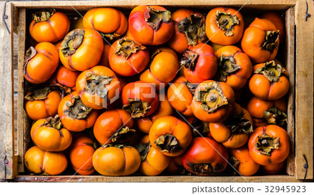 Box of fresh fruits persimmon kaki on wooden Box of fresh fruits persimmon kaki on wooden 32945923