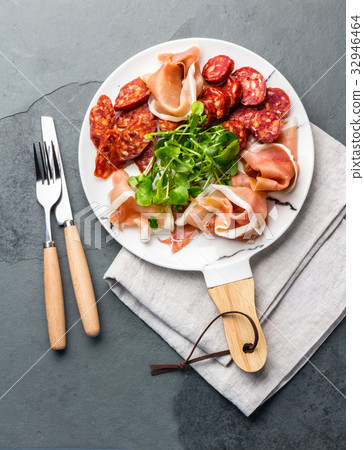 Spanish ham serrano and salami on white marbled Spanish ham serrano and salami on white marbled 32946464