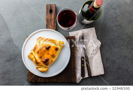Chilean empanada served on wite plate with red 32946500