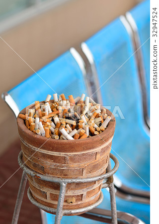 Smoked Cigarettes Butts in a Dirty Ashtray Big Bin Smoked Cigarettes Butts in a Dirty Ashtray Big Bin 32947524
