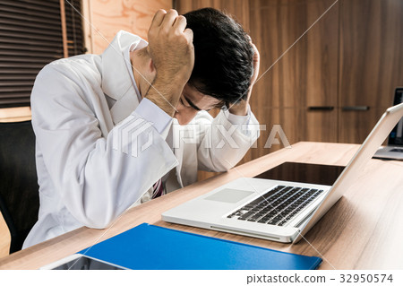A man in a white coat suffering 32950574