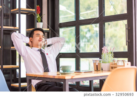 Businessman relaxing in a cafe. Businessman relaxing in a cafe. 32950693