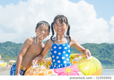 Schoolchild in a swimsuit playing in the sea Schoolchild in a swimsuit playing in the sea 32950909