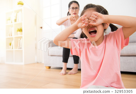 girl sitting on the wooden floor crying 32953305