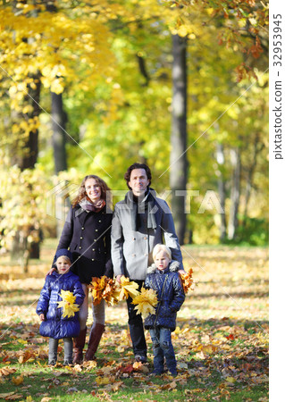 Family with children walking in autumn park Family with children walking in autumn park 32953945