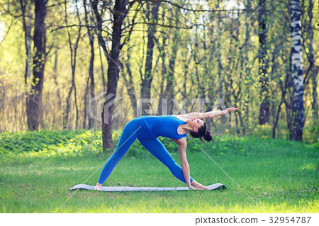 Young woman doing yoga exercises in the summer Young woman doing yoga exercises in the summer 32954787