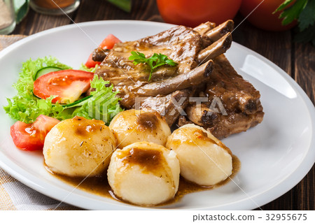 Pork spareribs served with silesian noodles Pork spareribs served with silesian noodles 32955675